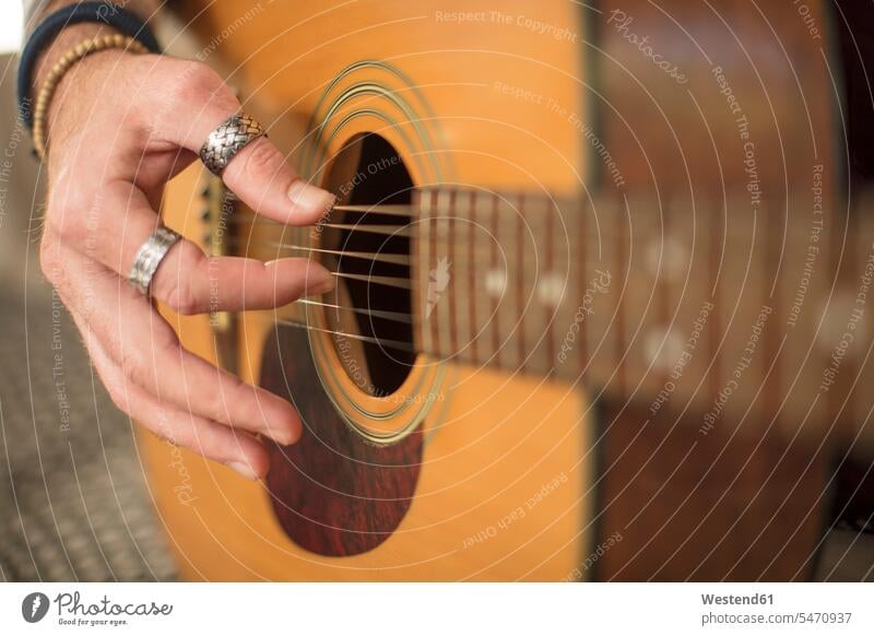 Close-up of man's hand playing guitar making music playing music make music play music human hand hands human hands guitars men males people persons human being