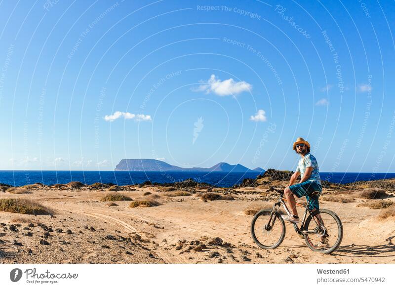 Man on a bicycle, La Graciosa island, Lanzarote, Canary Islands, Spain human human being human beings humans person persons caucasian appearance