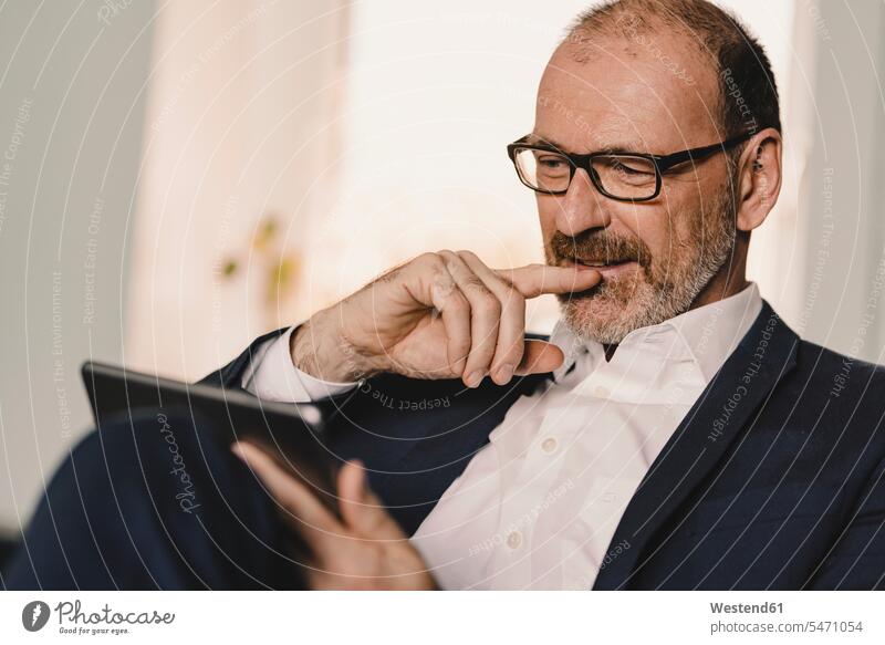 Portrait of confident mature businessman using a tablet human human being human beings humans person persons caucasian appearance caucasian ethnicity european