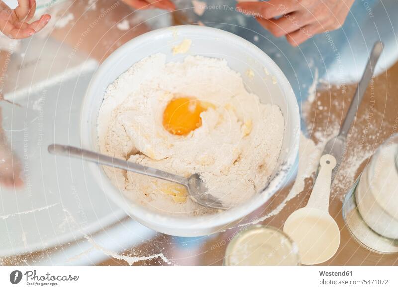Egg in cake batter on kitchen table Bowl Bowls Part Of partial view cropped preparing Food Preparation preparing food glass glassware Cake Mixture cake mix