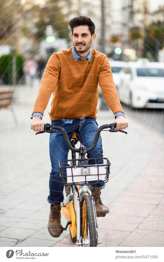 Portrait of young man riding rental bike in the city City Bike Citi Bike bicycle bikes bicycles driving drive riding bicycle riding bike bike riding cycling