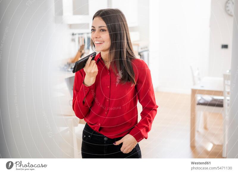 Smiling young businesswoman using smartphone at home human human being human beings humans person persons caucasian appearance caucasian ethnicity european 1