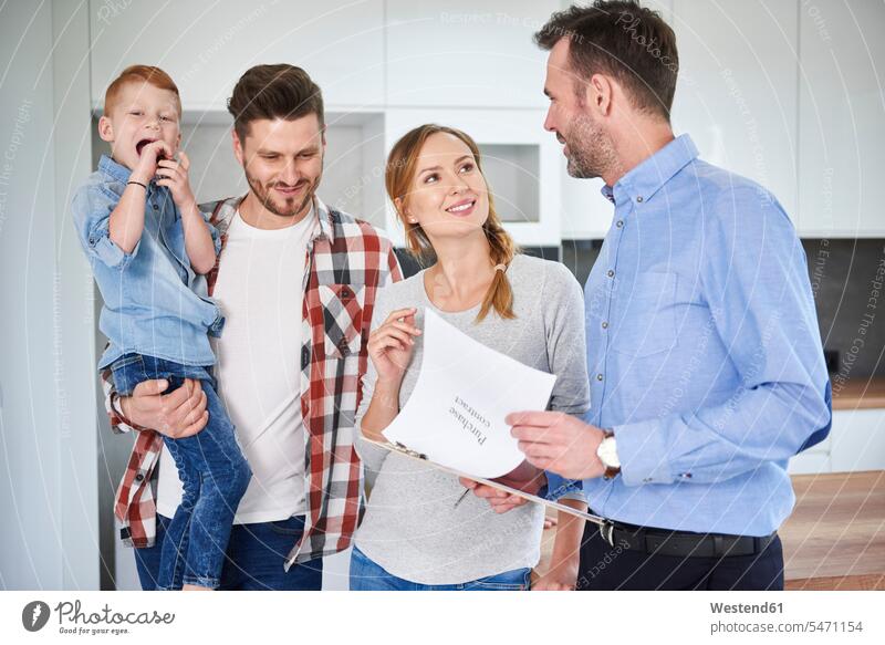 Family and real estate agent talking in new apartment realtor speaking family families flat flats apartments people persons human being humans human beings