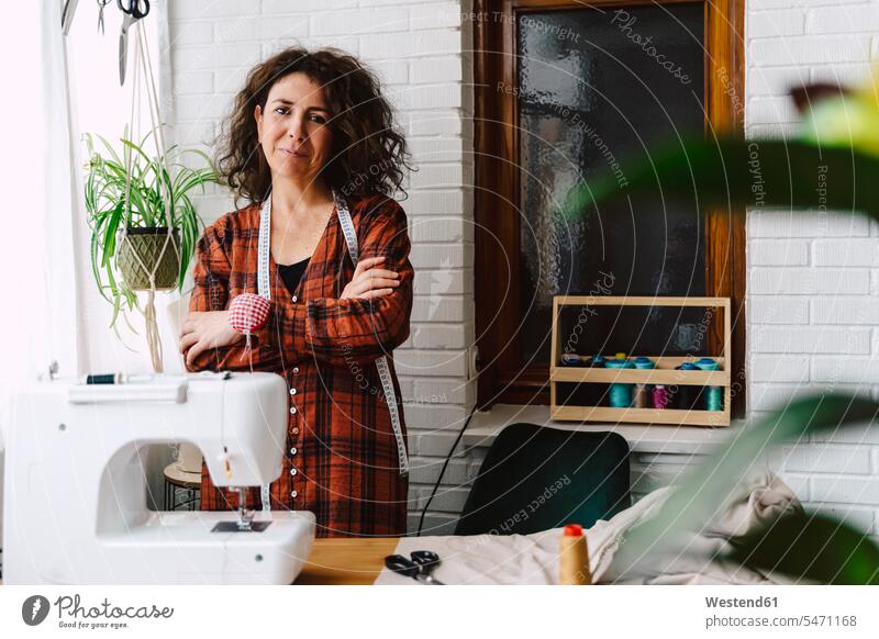 Portrait of confident woman with sewing machine at home Occupation Work job jobs profession professional occupation human human being human beings humans person