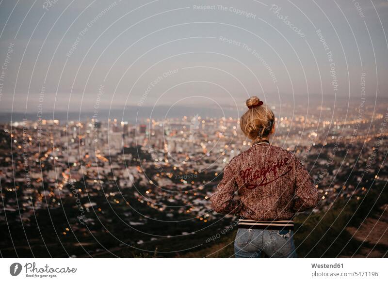 South Africa, Cape Town, Kloof Nek, woman woman looking at cityscape at sunset females women sunsets sundown eyeing standing Adults grown-ups grownups adult