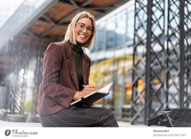 Portrait of happy young businesswoman with notebook in the city business life business world business person businesspeople business woman business women