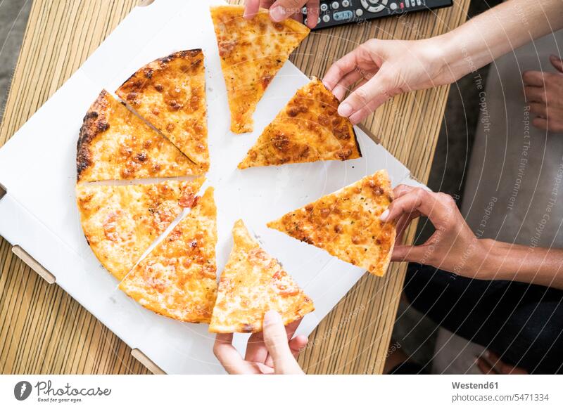 Friends eating pizza from a box, taking pieces Spain chunks part parts hand human hand hands human hands Lunch people persons human being humans human beings