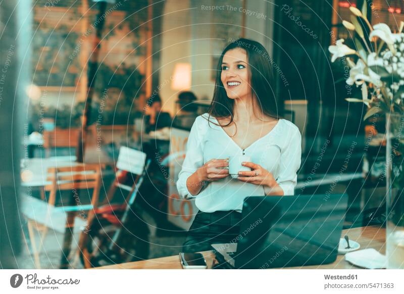 Portrait of laughing young woman waiting in a coffee shop portrait portraits businesswoman businesswomen business woman business women Laughter females cafe