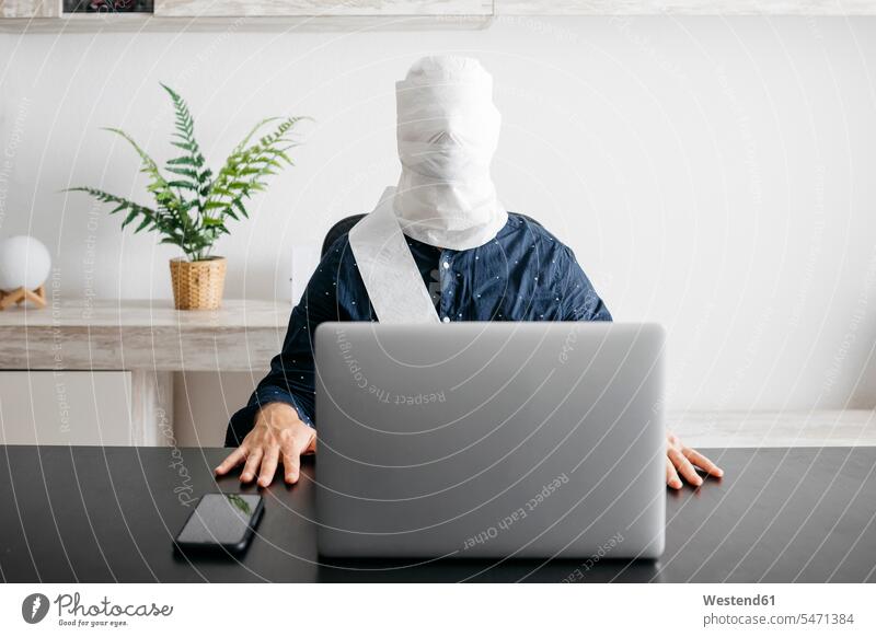Man working at home with his head covered in toilet paper human human being human beings humans person persons caucasian appearance caucasian ethnicity european