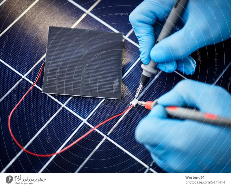 Technician measuring resistor of silicon solar cell human human being human beings humans person persons caucasian appearance caucasian ethnicity european 1
