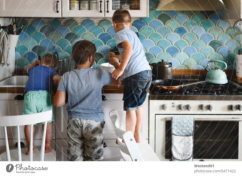 Three brothers cooking pancakes in the kitchen human human being human beings humans person persons caucasian appearance caucasian ethnicity european Group