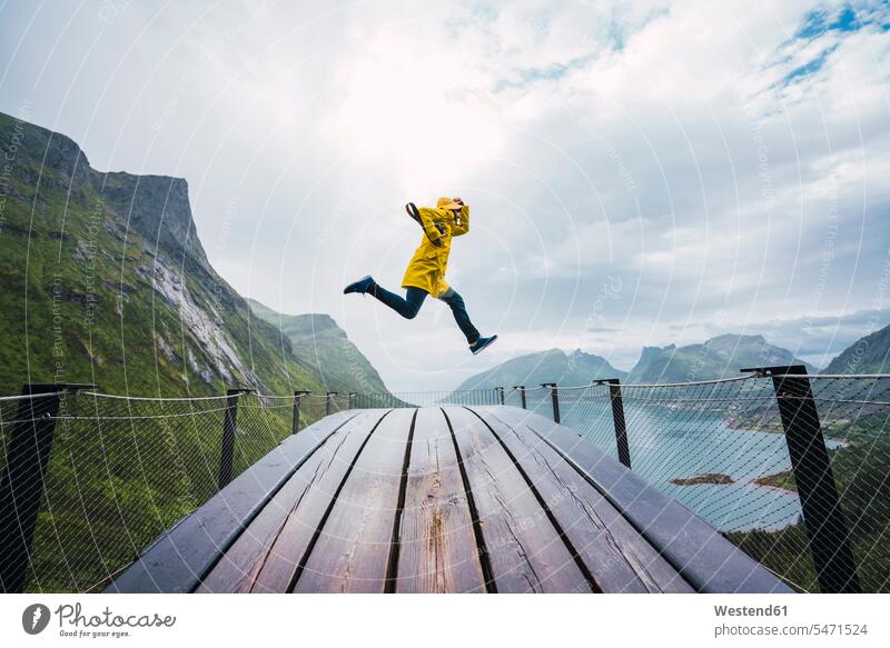 Norway, Senja island, man jumping on an observation deck at the coast coastline shoreline men males Leaping viewing platform Adults grown-ups grownups adult