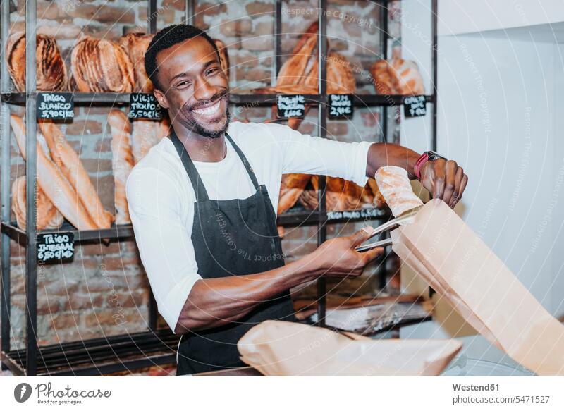 Smiling man working in a bakery Occupation Work job jobs profession professional occupation trading Sales Assistant Sales Assistants Sales Clerk sales clerks