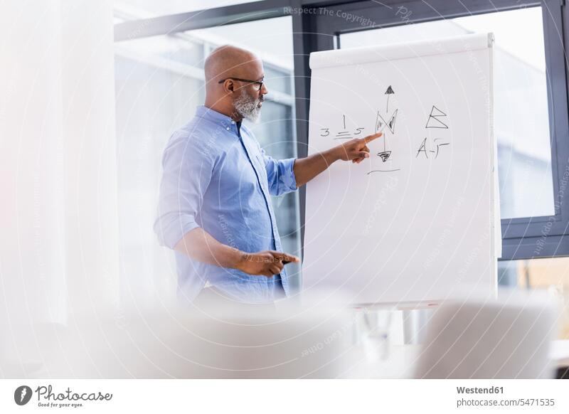 Businessman in conference room leading a presentation presentations Business man Businessmen Business men Event Events business people businesspeople
