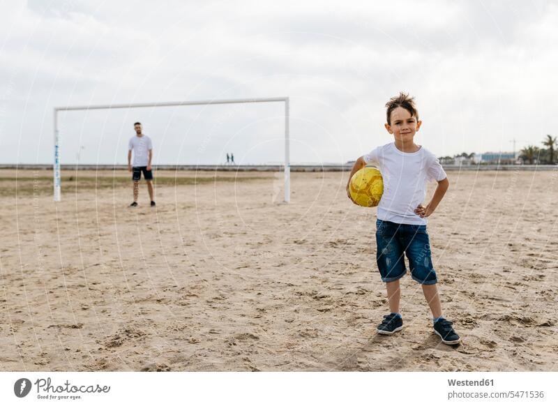 Portrait of boy with football on the beach human human being human beings humans person persons caucasian appearance caucasian ethnicity european 2 2 people