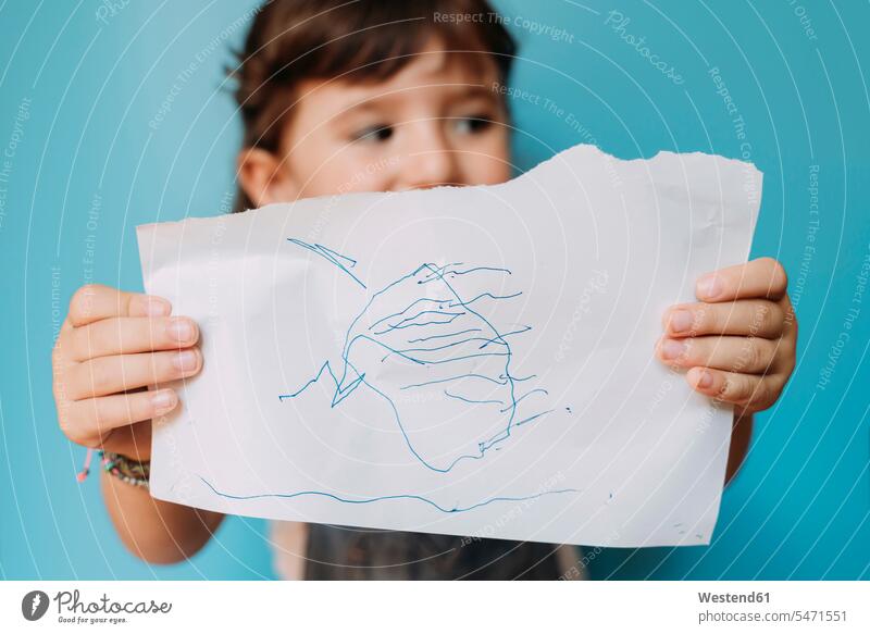 Little girl holding a handmade drawing on blue background images picture pictures drawings Child's Drawings children's drawing Childs Drawing paint