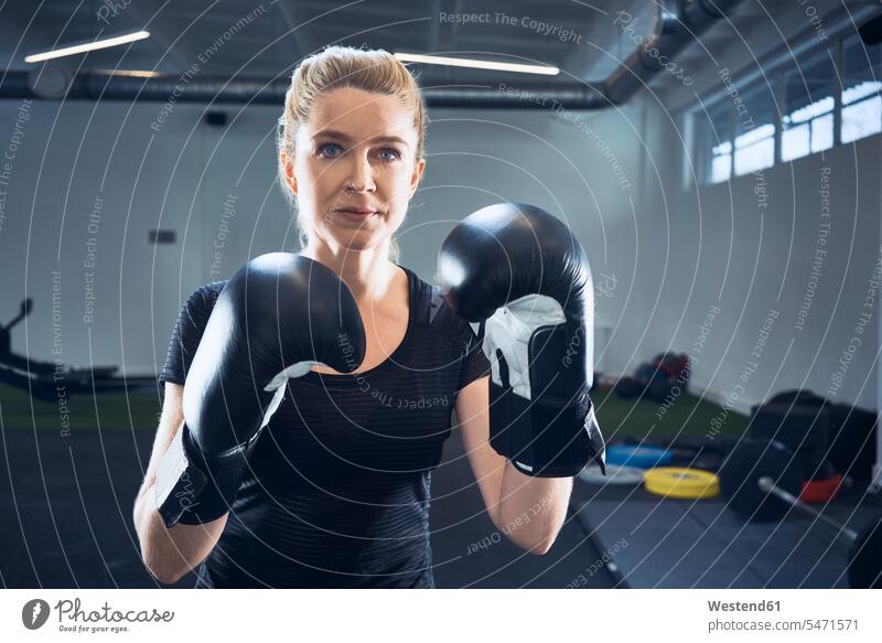 Portrait of woman practicing boxing at gym portrait portraits training Sport Training gyms Health Club martial arts combative sport females women sportive