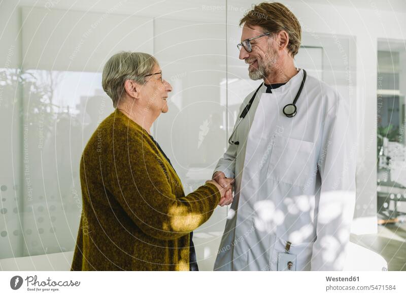 Doctor and senior patient in medical practice shaking hands health healthcare Healthcare And Medicines medicine disease diseases ill illnesses sick Sickness