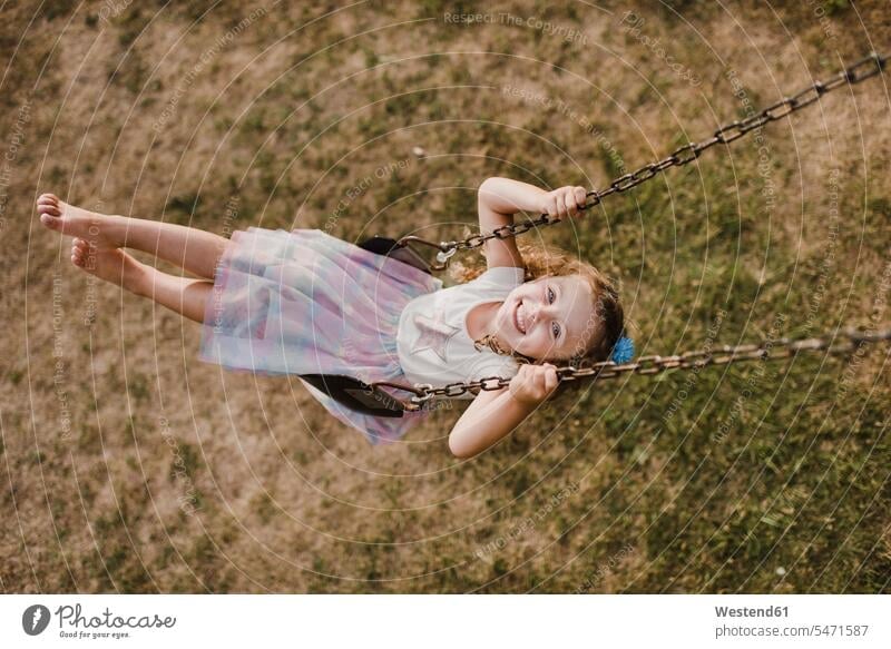 Happy little girl on a swing skirts playground swing Swing - Play Equipment swing set swings swingset relaxing smile seasons summer time summertime summery