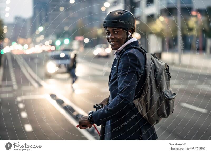 Portrait of smiling businessman with push scooter on bicycle lane in the evening business life business world business person businesspeople Business man