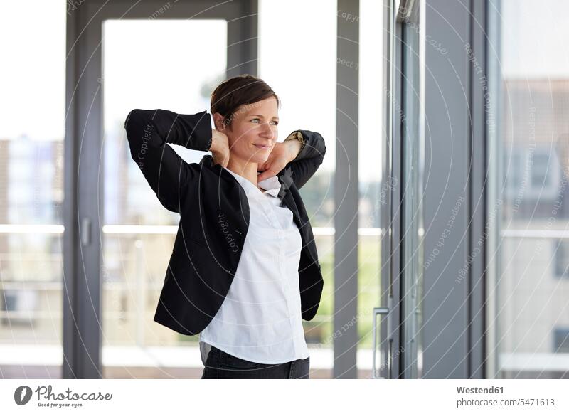 Businesswoman in office looking out of window looking sideways sideways glance Sideway Glance side glance windows view seeing viewing businesswoman