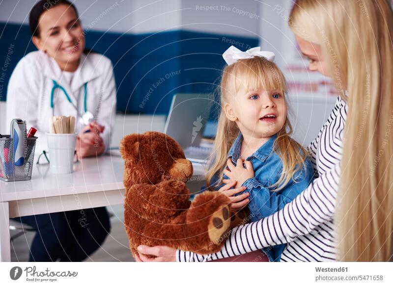 Mother with girl and teddy in medical practice mother mommy mothers ma mummy mama teddies females girls medical practices Doctors Office Doctor's Office