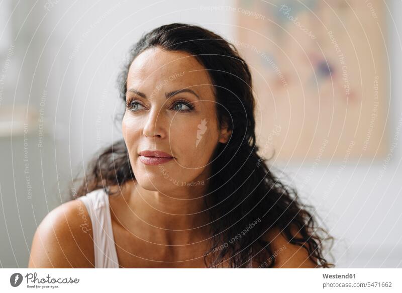 Close-up of thoughtful beautiful woman sitting in loft at home color image colour image Germany indoors indoor shot indoor shots interior interior view