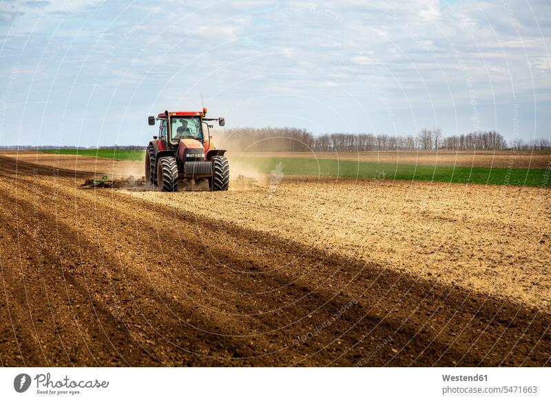 Farmer in tractor plowing field in spring human human being human beings humans person persons 1 one person only only one person Non Urban Scene non-urban