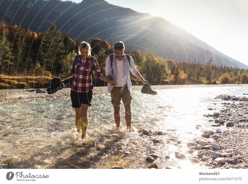 Austria, Alps, couple on a hiking trip wading in a brook caucasian caucasian appearance caucasian ethnicity european White - Caucasian mature men mature man