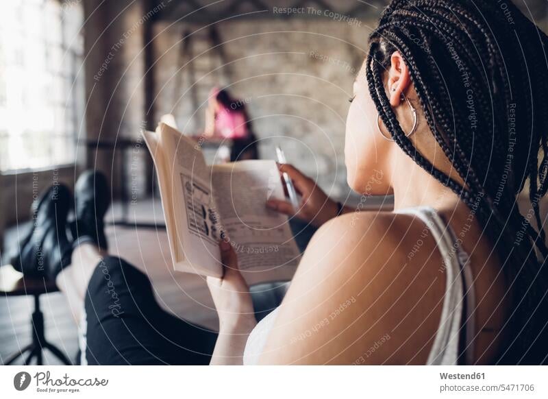 Young woman reading a book in loft office Occupation Work job jobs profession professional occupation business life business world business person