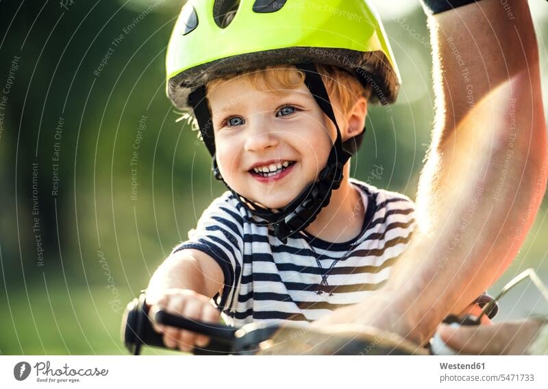 Portrait of smiling toddler wearing cycling helmet smile portrait portraits toddlers infants toddler age Toddler Bike Helmet bicycle helmet bicycle helmets
