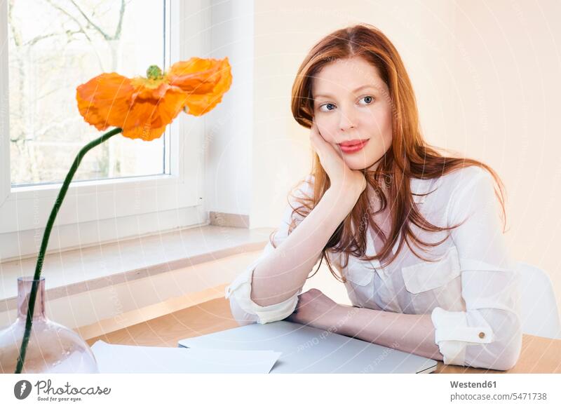 Portrait of redheaded woman at home office red hair red hairs red-haired females women portrait portraits working from home home business people persons