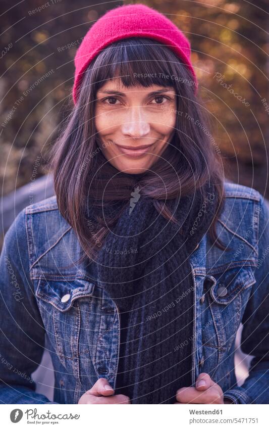 Portrait of smiling woman wearing red woolly hat and denim jacket human human being human beings humans person persons caucasian appearance caucasian ethnicity