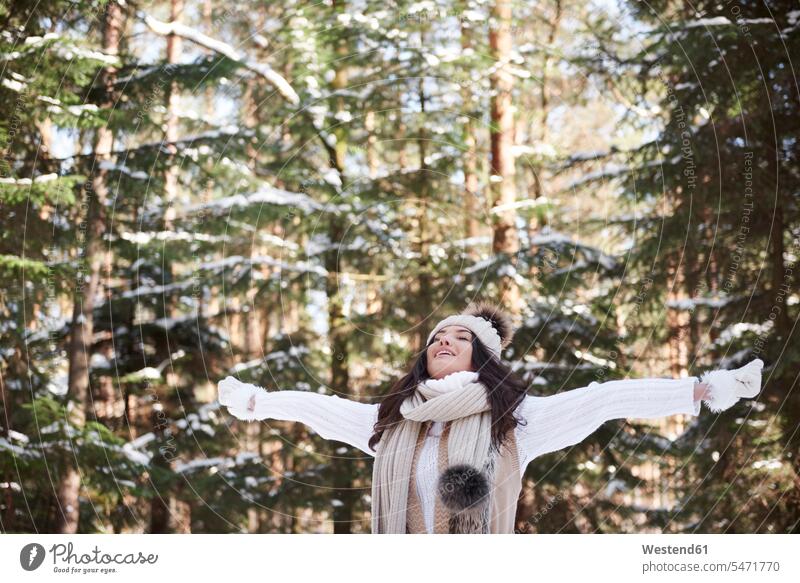 Young woman relaxing in winter forest relaxation hibernal females women woods forests Adults grown-ups grownups adult people persons human being humans