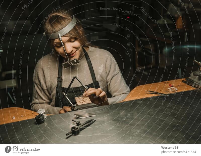 Artisan making jewellery in his workshop caucasian caucasian ethnicity caucasian appearance european manufacture producing manufacturing sitting Seated jewelry