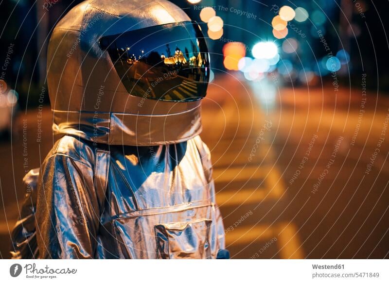 Spaceman on a street in the city at night road streets roads spaceman spacemen town cities towns astronaut astronauts by night nite night photography