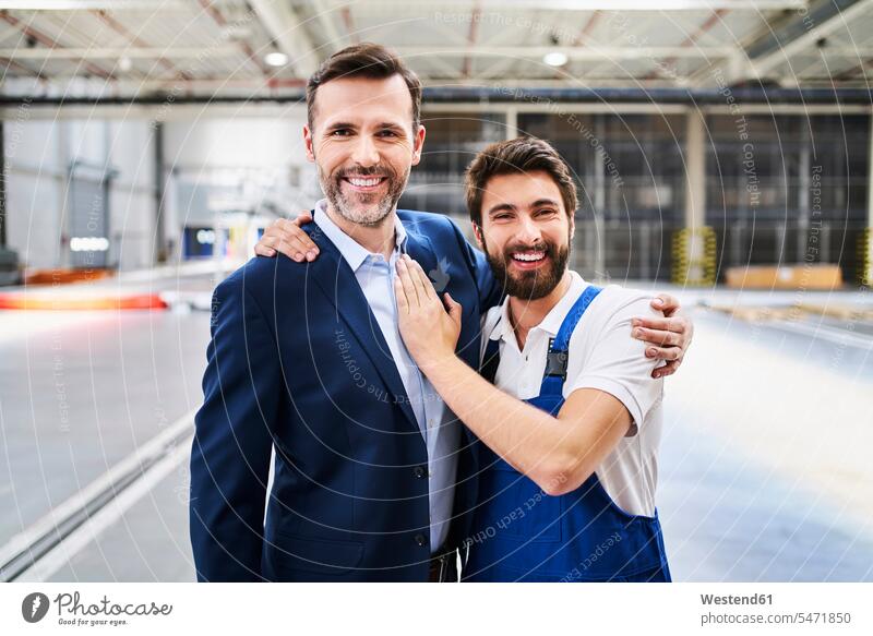 Portrait of happy businessman and worker in a factory human human being human beings humans person persons caucasian appearance caucasian ethnicity european 2