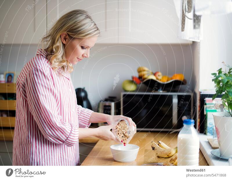Woman preparing breakfast in the kitchen at home Breakfast woman females women Food Preparation preparing food Meals foods food and drink Nutrition Alimentation