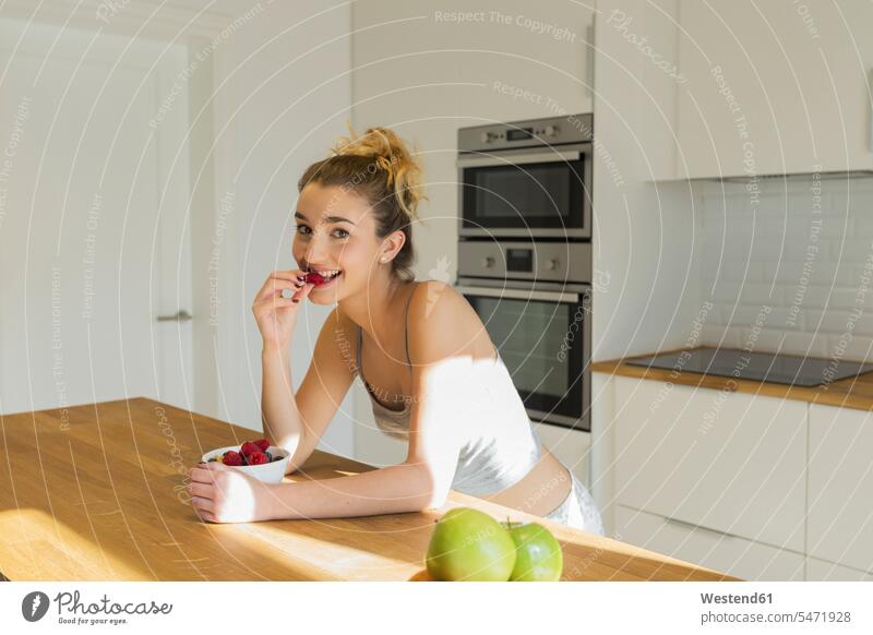 Female teenager during breakfast in the kitchen Bowls in the morning hunger at home free time leisure time Distinct individual Alimentation food Food and Drinks