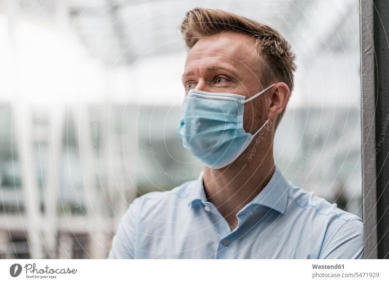 Businessman wearing mask in city during pandemic color image colour image outdoors location shots outdoor shot outdoor shots day daylight shot daylight shots