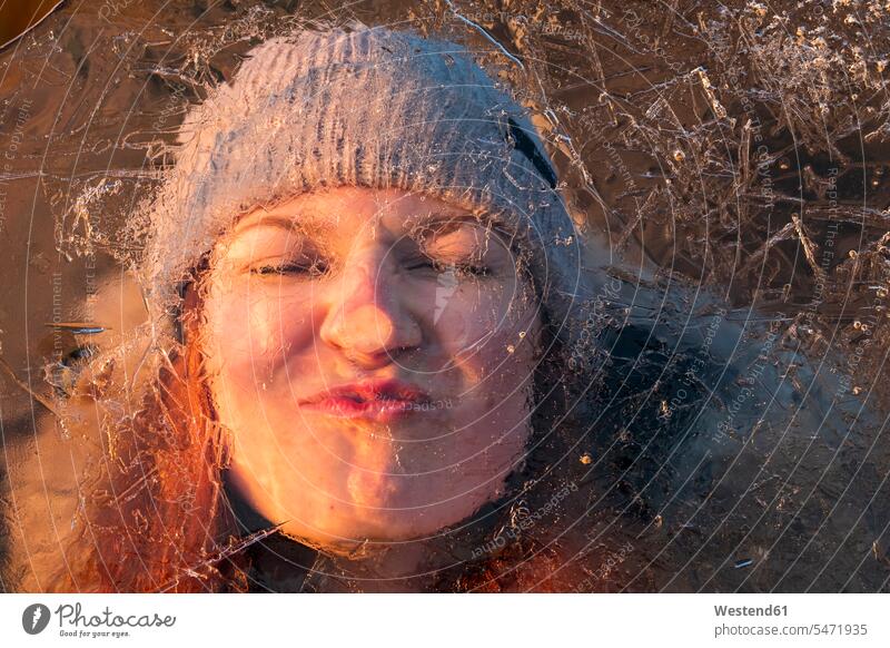 Portrait of teenage girl pulling funny face behind ice-covered surface seasons hibernal chilly Cold Temperature Cold Weather Humor Humorous surfaces having fun