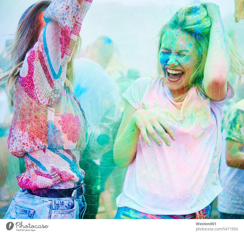 Friends dancing at music festival, holi powder colour powder color powder colored powder Powder Color coloured powder powders portrait portraits woman females