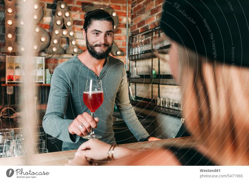 Barkeeper serving woman a cocktail human human being human beings humans person persons caucasian appearance caucasian ethnicity european 2 2 people 2 persons