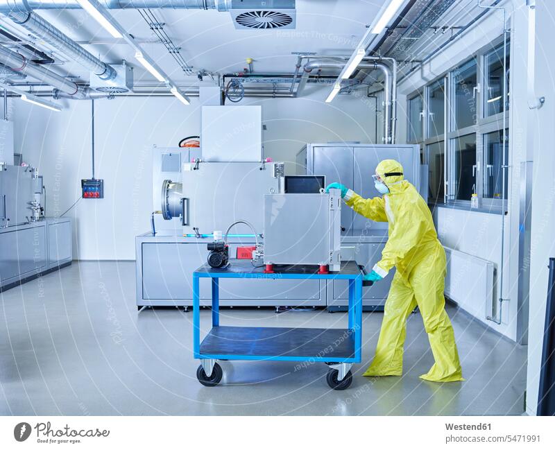 Chemist working in industrial laboratory clean room Chemical Laboratory At Work Protective Suit chemist sterile clothing hygiene natural scientist science