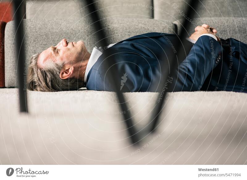 Mature businessman lying on carpet with closed eyes Businessman Business man Businessmen Business men carpets rug rugs laying down lie lying down