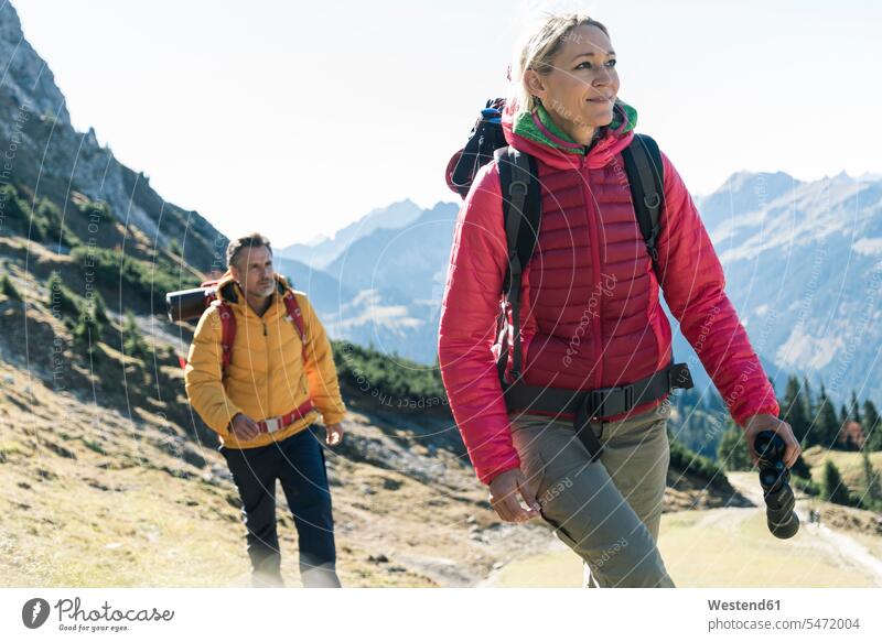 Austria, Tyrol, couple hiking in the mountains mountain range mountain ranges hike twosomes partnership couples landscape landscapes scenery terrain