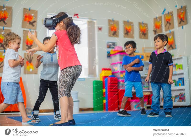 Children with VR glasses playing in kindergarten virtual nursery school specs Eye Glasses spectacles Eyeglasses child children kid kids pedagogics people
