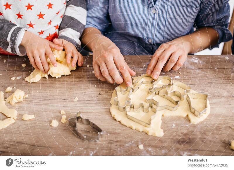 Mother and son cutting out cookies, partial view mother mommy mothers ma mummy mama Biscuit Cookie Cooky Cookies Biscuits sons manchild manchildren trumping