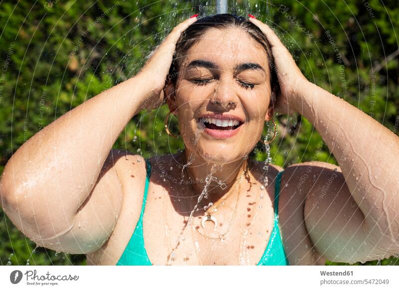 Portrait of young woman taking shower outdoors showers females women portrait portraits showering Adults grown-ups grownups adult people persons human being
