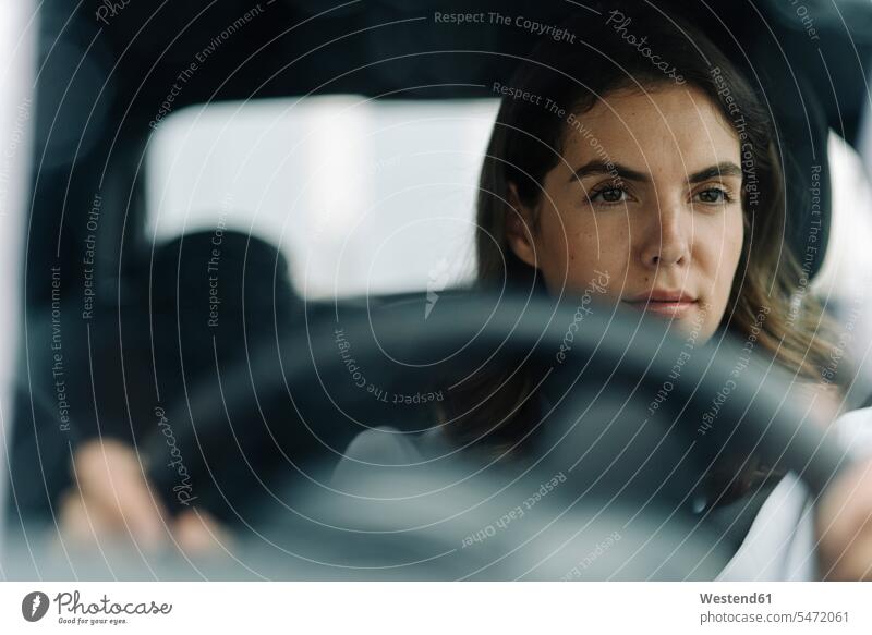Young woman driving car color image colour image Vehicle Interior day daylight shot daylight shots day shots daytime occupation profession